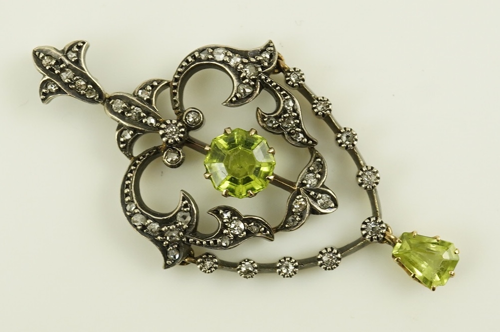 A Victorian gold and silver, peridot and diamond cluster set articulated drop pendant